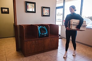 Lobby entrance with woman holding pet carrier